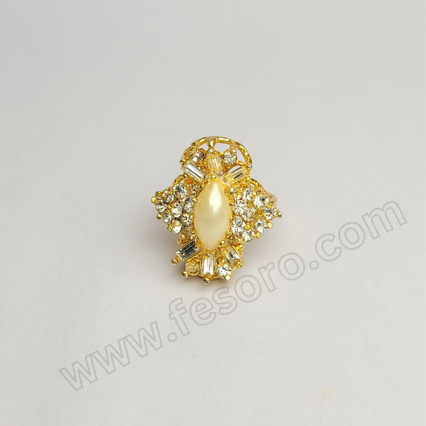 A Golden pearl 24 carat gold polish diamond oval ring